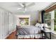 Bedroom with hardwood floors, ceiling fan, and bright windows, offering plenty of natural light at 19 Avondale Ave, Charleston, SC 29407