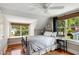 Cozy bedroom featuring hardwood floors, ceiling fan, and bright windows with a window seat at 19 Avondale Ave, Charleston, SC 29407