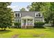 Inviting cape cod featuring a front porch,dormers, and manicured lawn at 19 Avondale Ave, Charleston, SC 29407