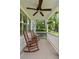 Covered porch with ceiling fan and rocking chairs at 19 Avondale Ave, Charleston, SC 29407