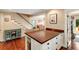 Kitchen island with seating in an open floor plan, adjacent to the staircase and living area at 19 Avondale Ave, Charleston, SC 29407