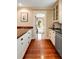 Open-concept kitchen with wood countertops, stainless steel appliances, and classic white cabinetry at 19 Avondale Ave, Charleston, SC 29407