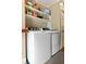 Laundry room with modern washer and dryer and built in shelving for storage at 19 Avondale Ave, Charleston, SC 29407