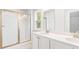 Bright bathroom featuring double sinks, white cabinetry, and a glass-enclosed shower at 214 Seele St, Summerville, SC 29485