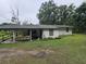 Covered back porch with swing bench adding a cozy spot to relax outdoors at 2200 State Road Rd, Summerville, SC 29486