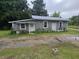 A gray block home with a metal roof, small yard, and two entry doors at 2200 State Road Rd, Summerville, SC 29486