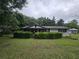 Home with nice, green front lawn featuring trimmed bushes for added privacy at 2200 State Road Rd, Summerville, SC 29486
