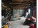 Interior view of a cluttered garage space with exposed beams and a lawn mower at 2200 State Road Rd, Summerville, SC 29486