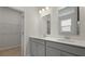 Dual-sink bathroom with quartz countertops, gray cabinetry and a walk-in closet at 222 Seele St, Summerville, SC 29485