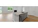 Kitchen island with granite countertops, stainless steel appliances, and hardwood floors enhance the open-concept space at 222 Seele St, Summerville, SC 29485