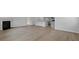 Open floor plan showcasing hardwood floors and fireplace, connecting the living area to the kitchen at 222 Seele St, Summerville, SC 29485