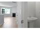 Stylish half-bath featuring a pedestal sink adjacent to a spacious living area at 222 Seele St, Summerville, SC 29485