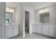 Dual vanity bathroom with white cabinets, granite countertops, and modern fixtures at 226 Seele St, Summerville, SC 29485