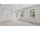 Bright bedroom features neutral carpet, double door closet, and natural light from two windows and access door at 226 Seele St, Summerville, SC 29485