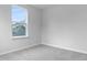 Carpeted bedroom featuring a window with neighborhood views, base molding, and neutral walls at 226 Seele St, Summerville, SC 29485