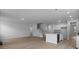 Open-concept living room with hardwood floors adjacent to the kitchen and staircase at 226 Seele St, Summerville, SC 29485