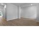 Open-concept living room with hardwood floors, base molding, and neutral walls, ready for personalization at 226 Seele St, Summerville, SC 29485