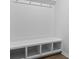 Bright mudroom features a white bench with cubbies for storage and hooks for hanging coats and bags at 226 Seele St, Summerville, SC 29485