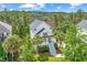 Aerial view of a charming two-story home nestled among lush trees near a marshland and golf course at 2301 N Creek Dr, Mount Pleasant, SC 29466