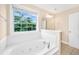 Bathroom features a tub with jets, a large window and a vanity at 2301 N Creek Dr, Mount Pleasant, SC 29466