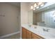 Bathroom featuring double sinks, wooden cabinets, and a large mirror at 2301 N Creek Dr, Mount Pleasant, SC 29466