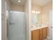 Bright bathroom with double vanity, glass shower door, and tiled walls at 2301 N Creek Dr, Mount Pleasant, SC 29466