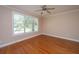Bright bedroom features hardwood floors, large window with blinds, and a ceiling fan at 2301 N Creek Dr, Mount Pleasant, SC 29466