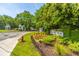 Welcome to Rivertowne! Landscaped entrance featuring lush greenery and community signage at 2301 N Creek Dr, Mount Pleasant, SC 29466