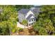 Rear exterior view of a two-story home with a deck and a palm tree in the landscaped backyard at 2301 N Creek Dr, Mount Pleasant, SC 29466