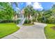 Exterior view of a home featuring a well-maintained lawn, landscaping and concrete driveway at 2301 N Creek Dr, Mount Pleasant, SC 29466