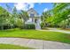 Charming two-story home with a well-manicured lawn, mature trees, and a driveway at 2301 N Creek Dr, Mount Pleasant, SC 29466