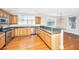 Bright kitchen with stainless steel appliances, wood cabinets, hardwood flooring, and abundant natural light at 2301 N Creek Dr, Mount Pleasant, SC 29466