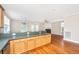 Kitchen with breakfast bar overlooking adjacent living room featuring hardwood flooring and large windows at 2301 N Creek Dr, Mount Pleasant, SC 29466