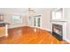 Bright living room featuring a fireplace, ceiling fan and hardwood flooring at 2301 N Creek Dr, Mount Pleasant, SC 29466