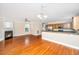 Open-concept living space featuring hardwood floors, a fireplace, and a modern kitchen with stainless steel appliances at 2301 N Creek Dr, Mount Pleasant, SC 29466