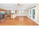 Open concept kitchen and living area with hardwood floors, stainless steel appliances, and fireplace at 2301 N Creek Dr, Mount Pleasant, SC 29466