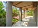 Covered porch with concrete flooring and ceiling fan overlooks lush greenery at 2301 N Creek Dr, Mount Pleasant, SC 29466