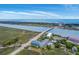 Expansive aerial view of coastal condos by a bridge, featuring beautiful waterfront scenery at 2393 Folly Rd # 1G, Folly Beach, SC 29439