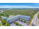 Aerial view of the condo complex near serene wetlands and a coastal highway at 2393 Folly Rd # 1G, Folly Beach, SC 29439