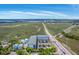Scenic aerial view of the condo buildings adjacent to marshland, highway, and waterway at 2393 Folly Rd # 1G, Folly Beach, SC 29439