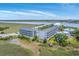 Stunning aerial view of condo building surrounded by lush greenery and waterways, perfect for coastal living and scenic beauty at 2393 Folly Rd # 1G, Folly Beach, SC 29439