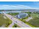Aerial perspective of coastal condos, a bridge, and lush marshland, offering stunning water scenery at 2393 Folly Rd # 1G, Folly Beach, SC 29439