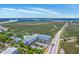 Scenic aerial view showcasing condo buildings near highway and the beautiful marshland waterway at 2393 Folly Rd # 1G, Folly Beach, SC 29439