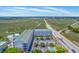Aerial view showcasing the condo with nearby highway, lush marshland, and waterway views at 2393 Folly Rd # 1G, Folly Beach, SC 29439