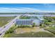 Breathtaking aerial view of a beautiful condo building with waterway access, featuring lovely views and architectural charm at 2393 Folly Rd # 1G, Folly Beach, SC 29439