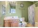 Cozy bathroom featuring a wooden vanity, toilet, and shower with patterned curtain at 2393 Folly Rd # 1G, Folly Beach, SC 29439