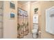 Bright bathroom with a shower and beach-themed decor at 2393 Folly Rd # 1G, Folly Beach, SC 29439