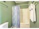 Bright bathroom features a shower and tub with a blue and purple patterned curtain at 2393 Folly Rd # 1G, Folly Beach, SC 29439