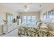 Cozy bedroom featuring a ceiling fan, dresser, and a balcony view at 2393 Folly Rd # 1G, Folly Beach, SC 29439