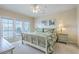 Bright bedroom featuring a ceiling fan, art, and balcony access at 2393 Folly Rd # 1G, Folly Beach, SC 29439
